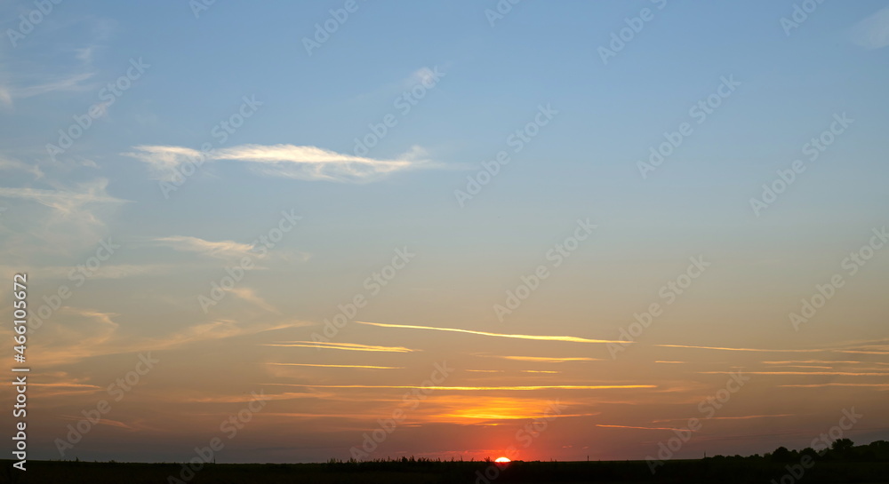 Scene of sunset in the summer with a cloudy sky background. Landscape