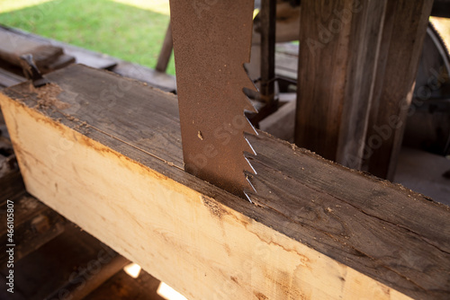 Vertical saw blade cuts lumber in a colonial sawmill