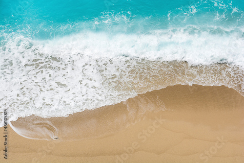 Aerial view of sandy beach and waves with copy space