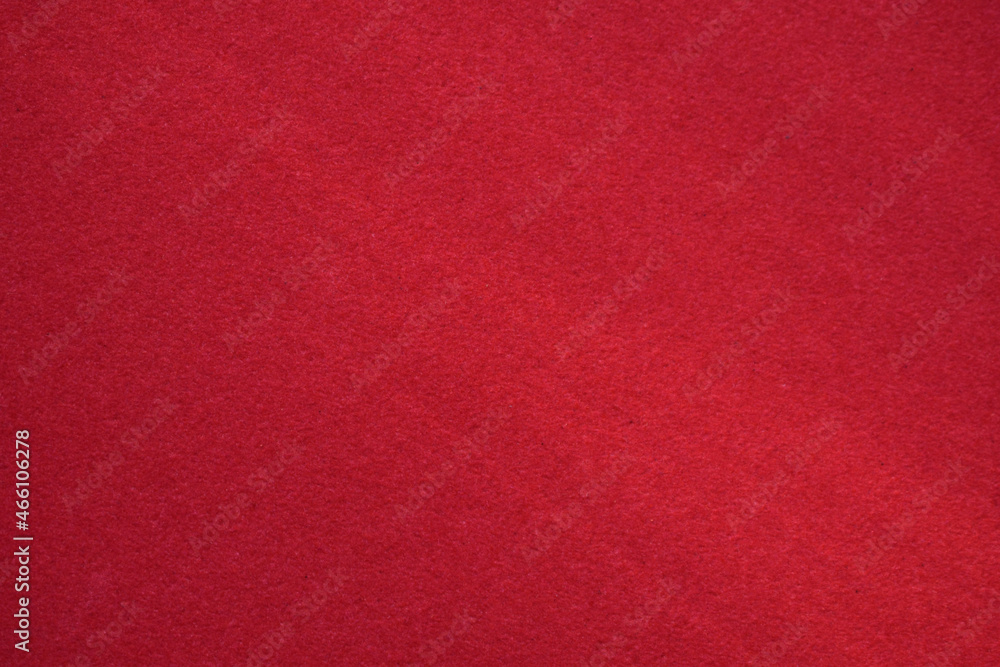 Red velvet paper background in the rays of the sun Red velvet paper background in the rays of the sun
