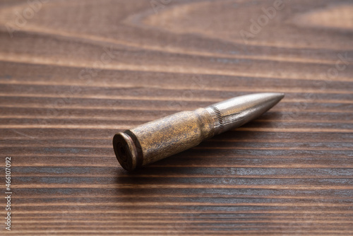 Bullet with a sleeve -Carton on a wooden table