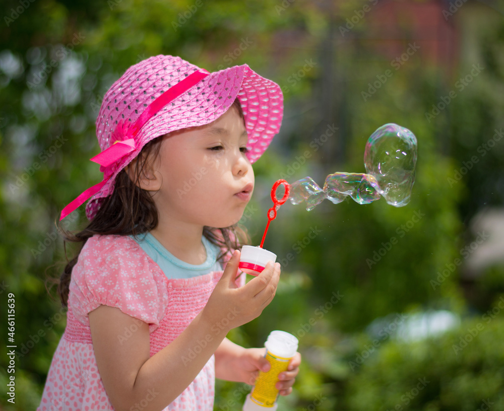 little girl blowing soap bubbles little girl blowing soap bubbles