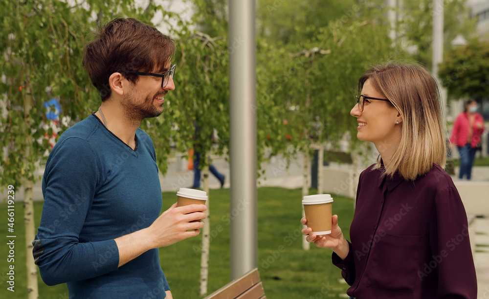 Fototapeta premium Smiling caucasian businesswoman and man Funny Coversation talking. Coworkers friendly discussion during lunch time. Happy Friends meeting.