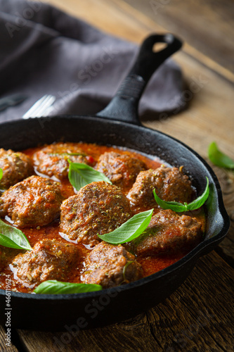 Homemade meatballs in tomato sauce with fresh basil