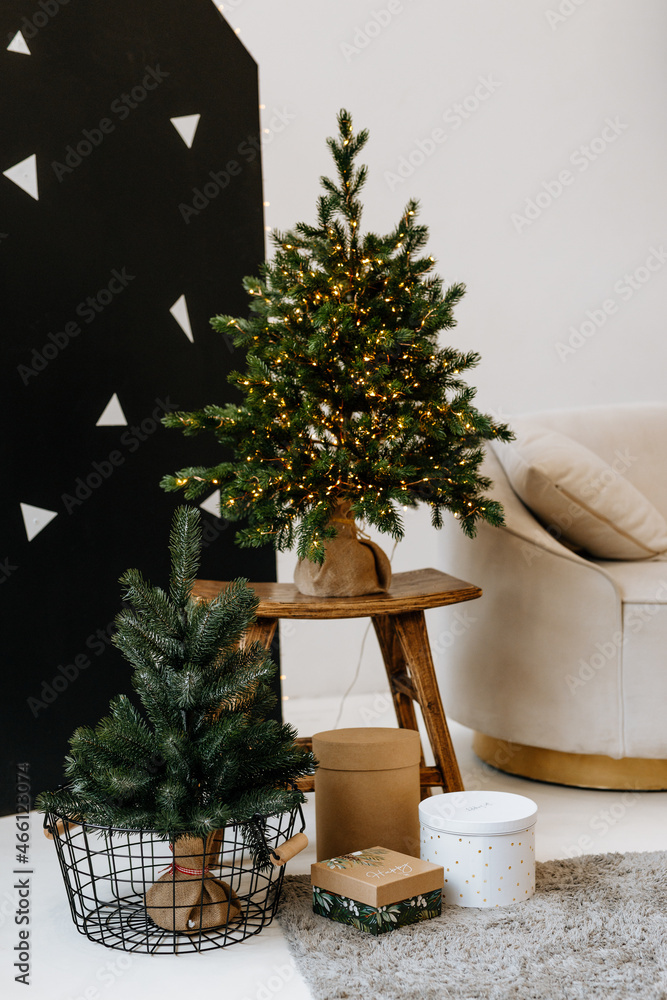Fototapeta premium Christmas cozy winter home decor. Christmas decorations of the interior. Cozy sofa with pillows on the background. The interior of the living room and recreation home decor concepts. 