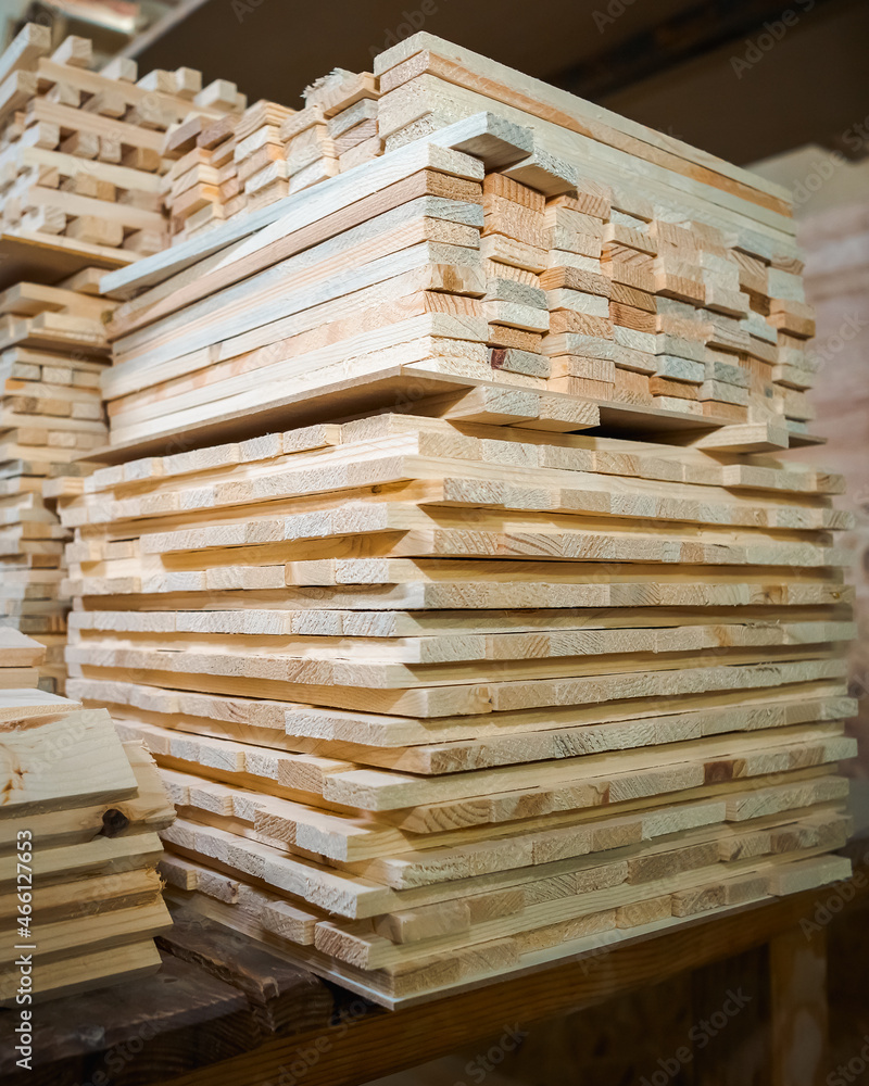 Pine wooden bar blocks materials stacked at carpentry woodwork workshop. Timber wood blanks at diy workbench. Close-up. Handcraft hobby