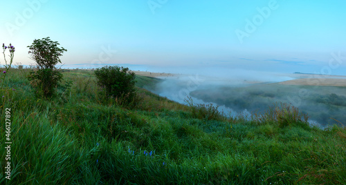 Foggy morning landscape with river and fields
