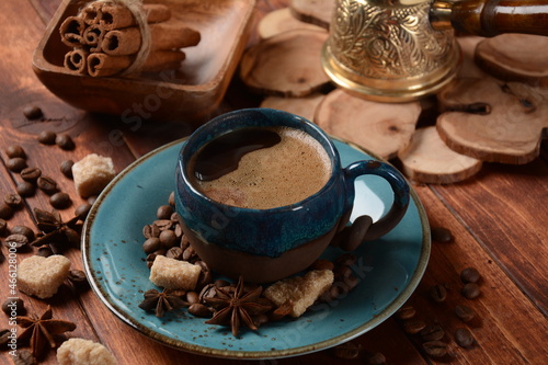 Coffee cup, demerara brown sugar cubes , сezve and beans on old kitchen table © Natalia Hanin