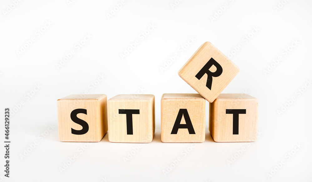 Start symbol. The concept word 'start' on wooden cubes. Beautiful white table, white background. Business and start concept. Copy space. Start symbol. The concept word 'start' on wooden cubes. Beautiful white table, white background. Business and start concept. Copy space.