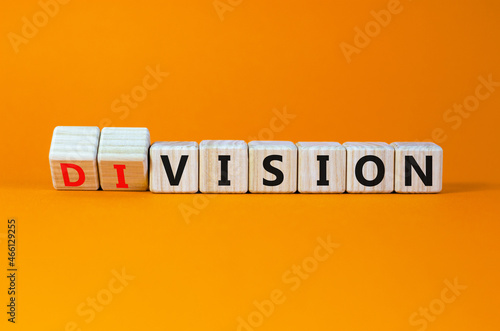 Division or vision symbol. Turned cubes and changed the word 'division' to 'vision'. Beautiful orange table, orange background. Business, division or vision concept. Copy space. photo