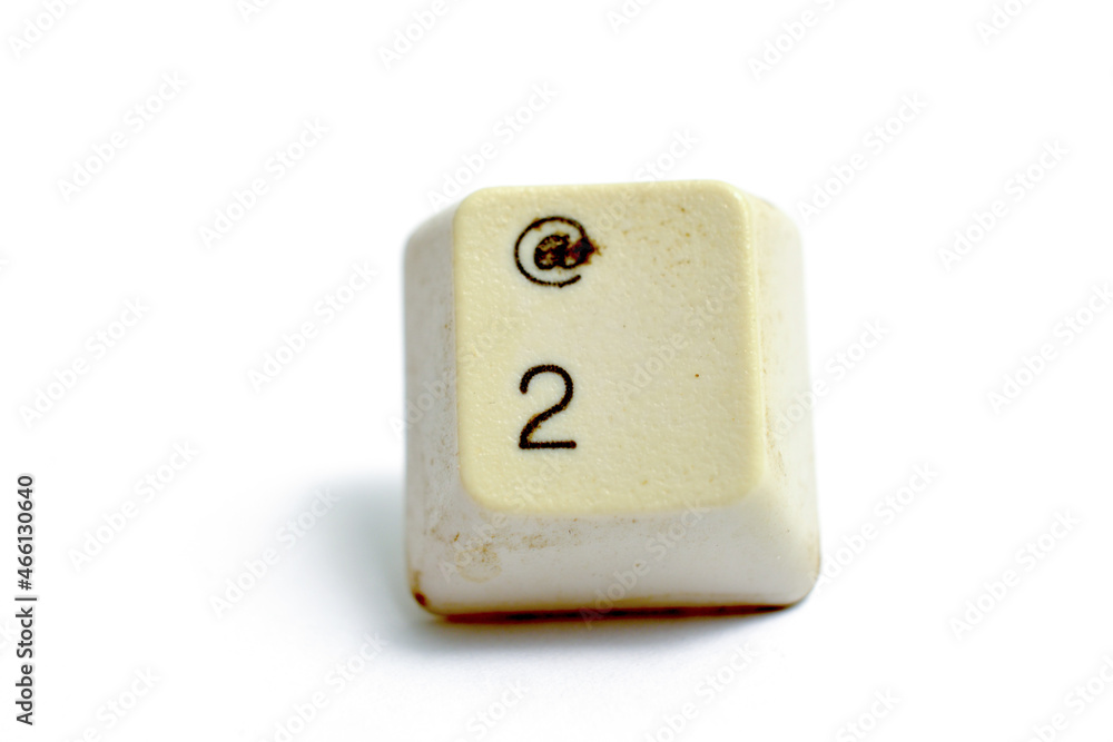 old used computer key number two isolated on white background . old used computer key number two isolated on white background .