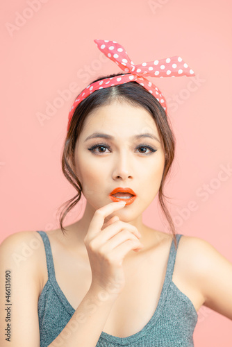 Close-up portrait of nice-looking asian girl thinking isolated over pink background
