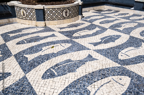 pavement representing fish and wall covered with azulejos in the old town of Faro, Algarve, Portugal