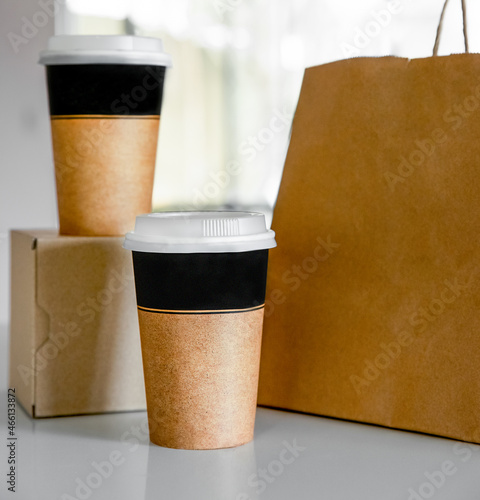 coffee in cardboard brown cups ordered and delivered for takeaway, food delivery, takeout, copy space for text. photo