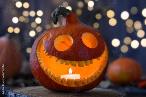 Smiling pumpkin on dark background with bokeh Halloween concept
