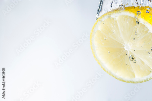 Yellow Lemon splashing Into Water, studio shot