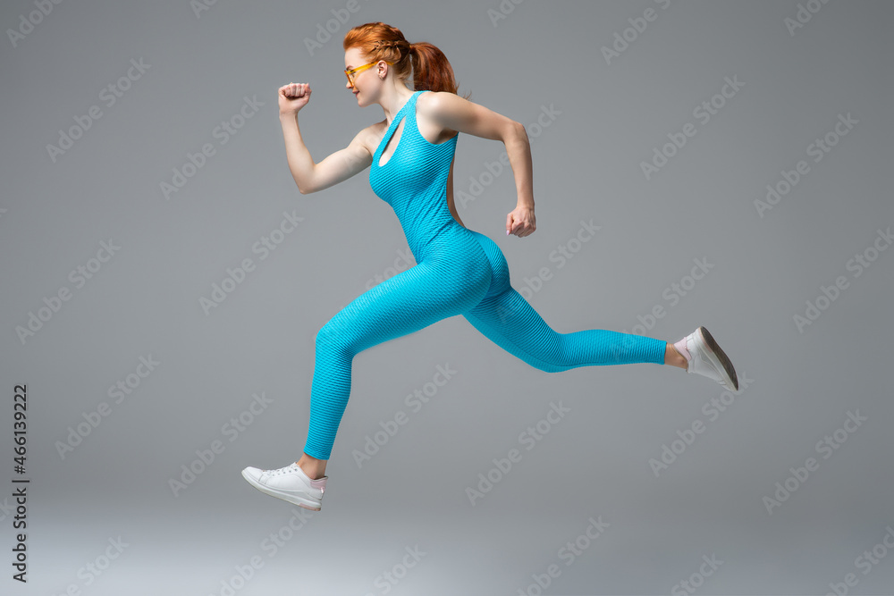 Fototapeta premium Strong female landing on ground during run