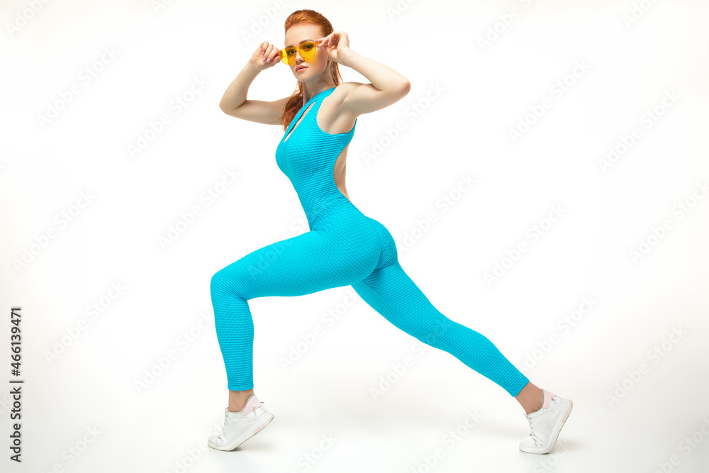 Strong female lunging and adjusting sunglasses