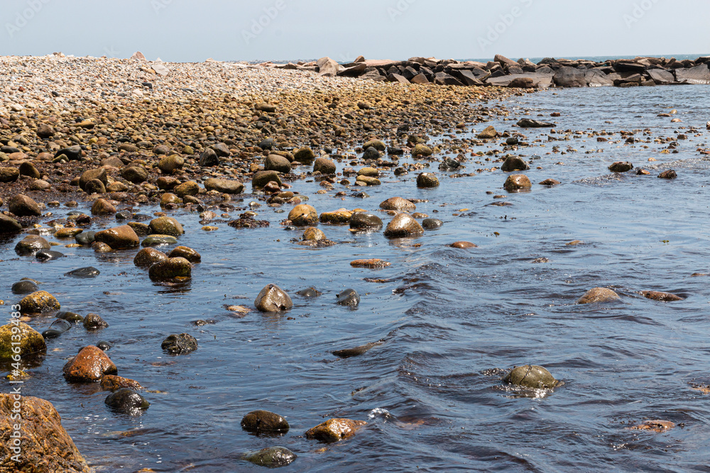 Rocky beach and rock jetty extending out into Narragansett Bay in Rhode Island Rocky beach and rock jetty extending out into Narragansett Bay in Rhode Island