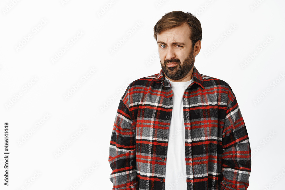 Yuck disgusting. Portrait of man cringe and look with dislike and aversion at something bad, grimacing, standing over white background Yuck disgusting. Portrait of man cringe and look with dislike and aversion at something bad, grimacing, standing over white background