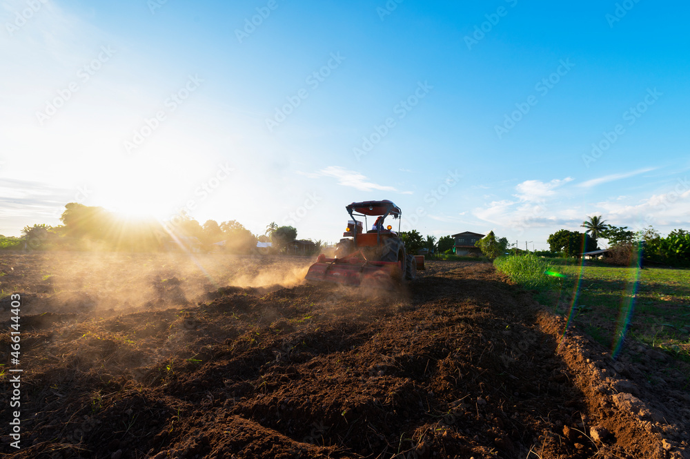 Fototapeta premium Agriculture with tractors prepare the soil with tillage as part of the pre-sowing activity in the early spring of the farm work. farmland