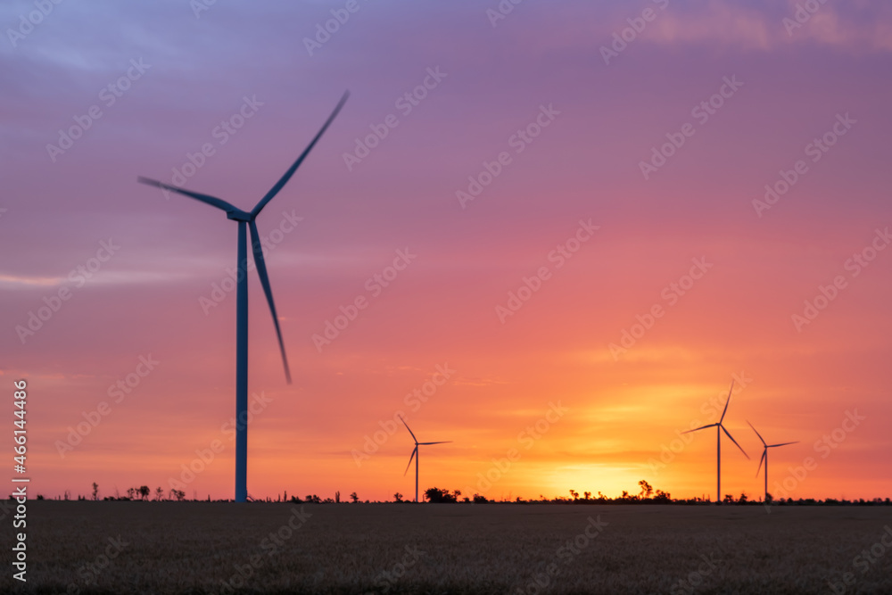 Wind turbines at dawn. Picturesque view of the wind power generator. Production of environmentally friendly energy. Wind turbines at dawn. Picturesque view of the wind power generator. Production of environmentally friendly energy.