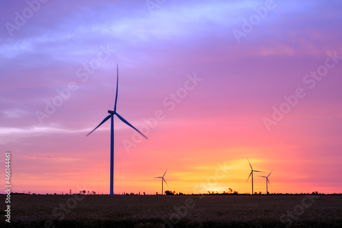 Wind turbines at dawn. Picturesque view of the wind power generator. Production of environmentally friendly energy.