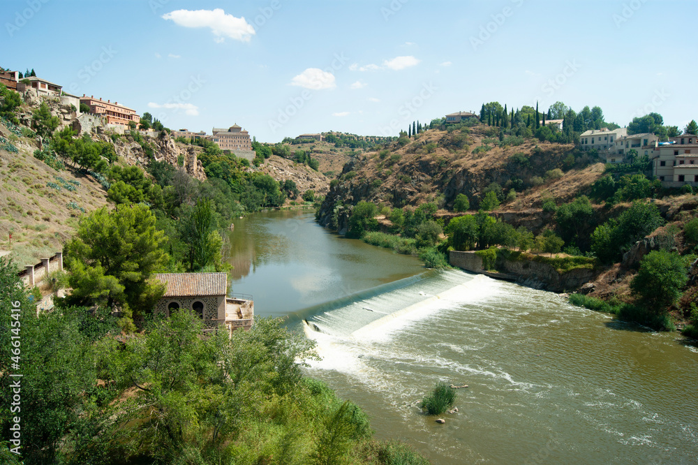 Toledo, Spain River Tagus seen from the Saint Martin bridge View of a beautiful river valley with wooded hillsides  Landscape aspect view with copy space