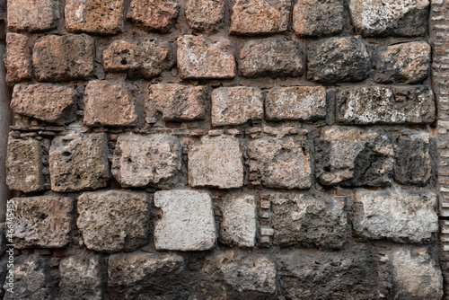 Stone and brick wall of an ancient building. Suitable as background and wallpaper pattern.