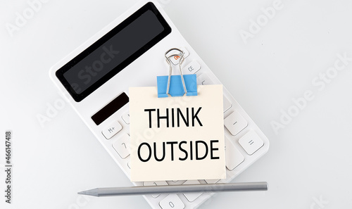THINK OUTSIDE text on the sticker on white calculator