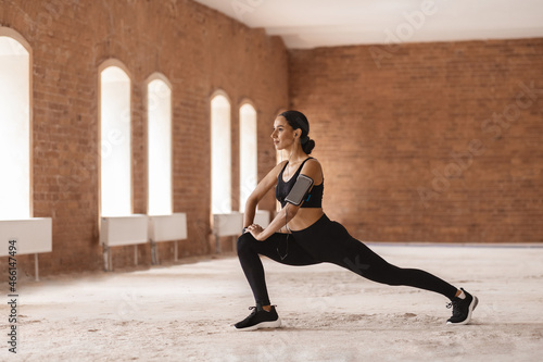 Portrait Of Athletic Young Lady Exercising Outdoors In Empty Urban Building