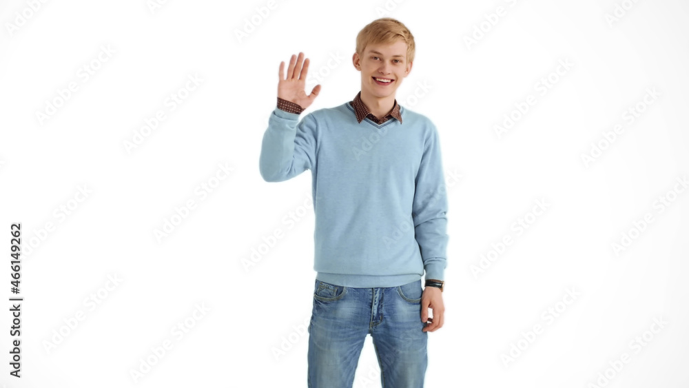 Portrait of friendly smiling man waving raised hand saying hello and looking happy Portrait of friendly smiling man waving raised hand saying hello and looking happy
