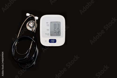 Sphygomanometer digital blood pressure monitor on white with hypotension concept. photo