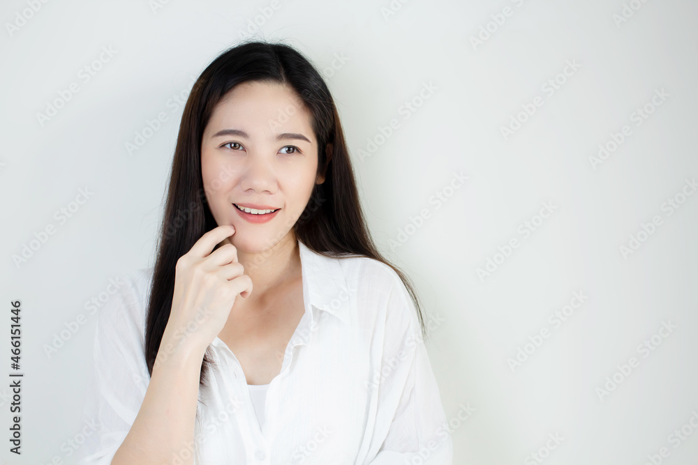Asian beautiful woman use finger touch chin are smiling with success in idea and thinking idea Asian beautiful woman use finger touch chin are smiling with success in idea and thinking idea
