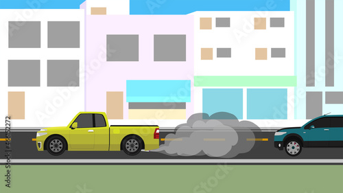Pickup trucks racing on city streets. It releases smoke and pollution to the cars that follow behind them. With city for backgorund at day.