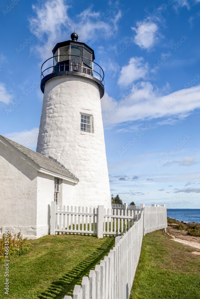 Surrounded by a white picket fence, the historic Pemaquid Point Lighthouse stands on the granite shore of the Atlantic Ocean at Bristol, Lincoln County, Maine.