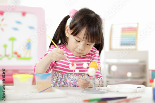 young girl making craft for homeschooling