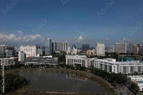 Ultra modern city and lake reflection on sunny  clear day featuring a mixture of architectural styles. Phu My Hung  District 7  Ho Chi Minh City  Vietnam