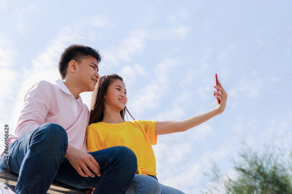 Self portrait of two asian teenager friends cloud sky background Self portrait of two asian teenager friends cloud sky background
