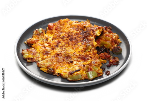 Egg omelette with slice leek and cubes tomato in plate isolated on white