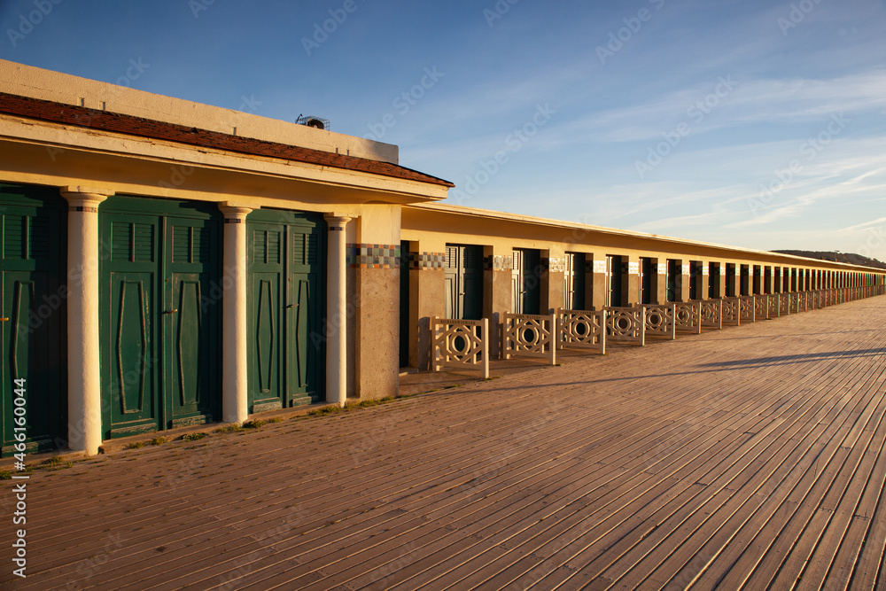 The famous beach cabins of the promenade des Planches in Deauville in France. The famous beach cabins of the promenade des Planches in Deauville in France.