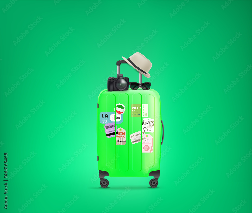 Travel bag with paper stickers, hat, digital camera and sunglasses. Travel bag with paper stickers, hat, digital camera and sunglasses.