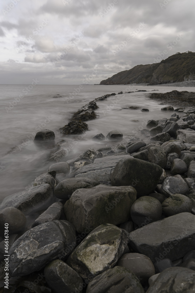 British Somerset beach landscape with rocks and soft waves