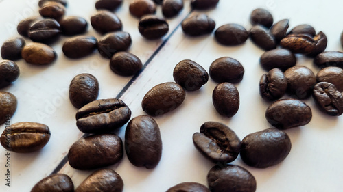 Fototapeta Naklejka Na Ścianę i Meble -  Organic Brazilian coffee beans background, scattered dark coffee beans