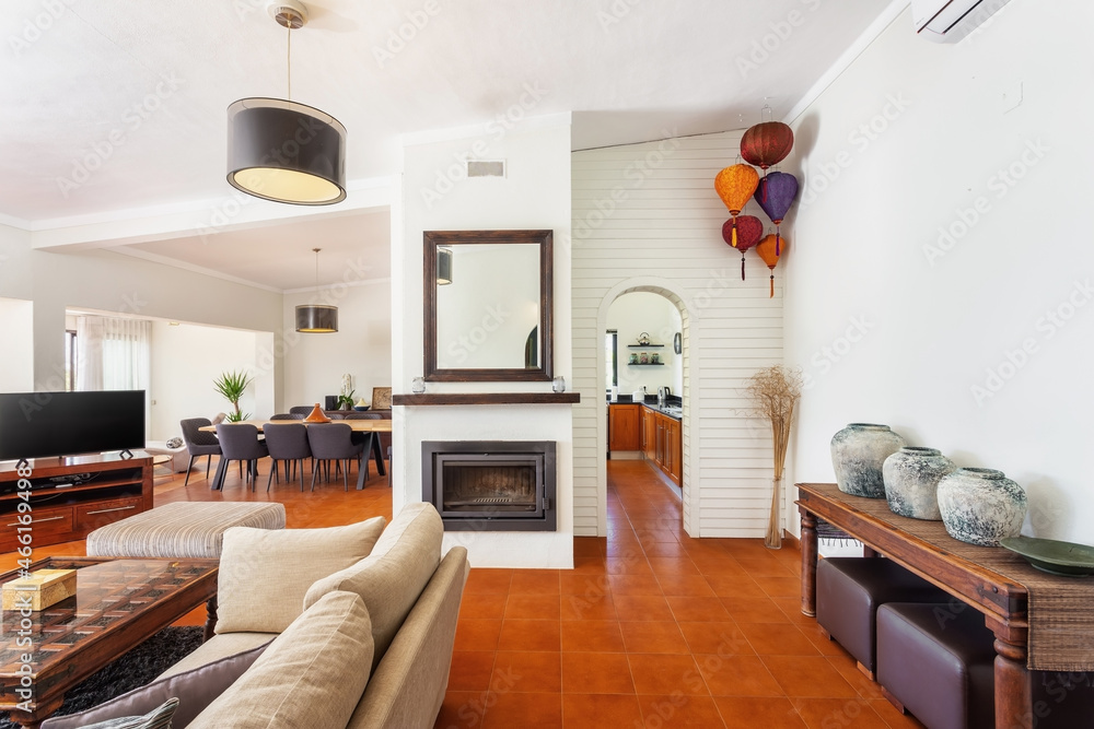 Fototapeta premium Modern traditional European living room with fireplace and coffee table and TV.