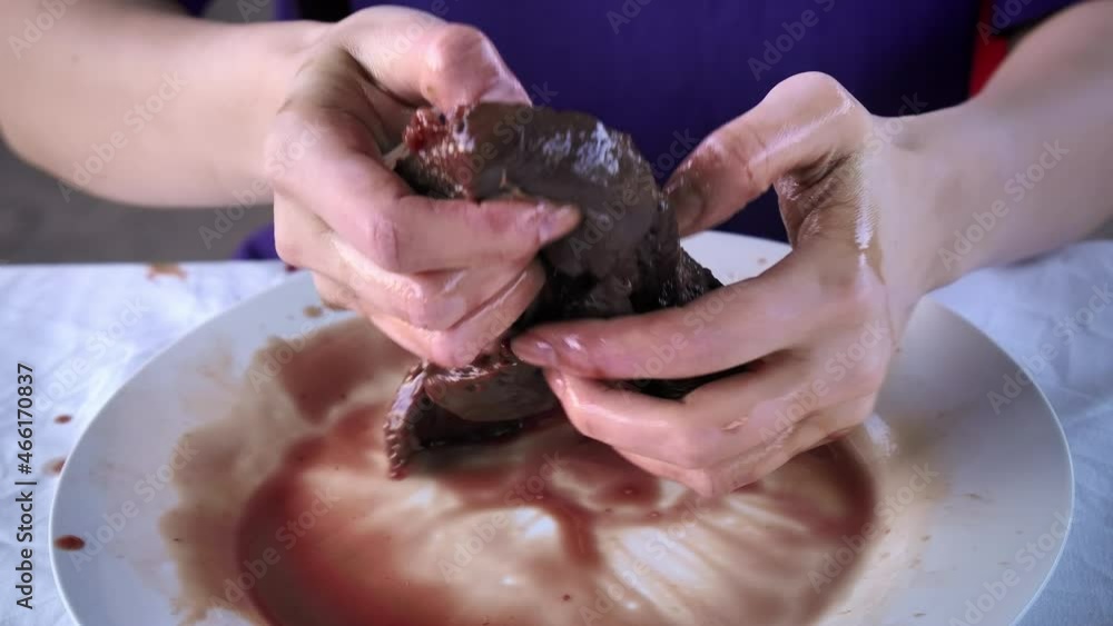 Close-up video of woman eating raw liver in sunner day