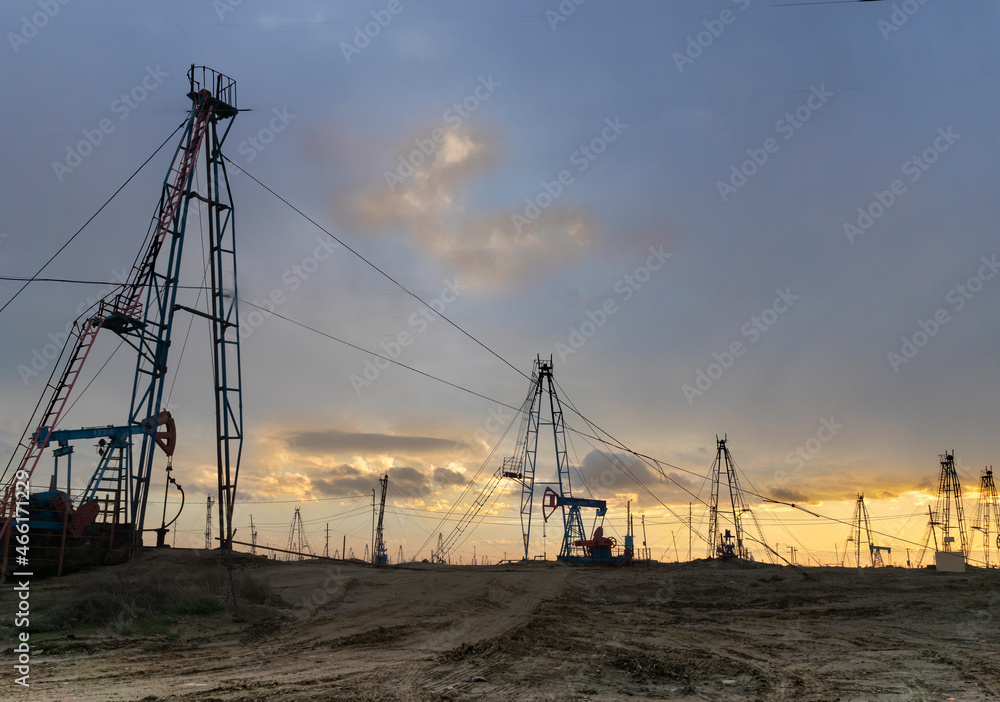 Oil production in the vicinity of Baku. Azerbaijan. Sunset. Evening. Oil fields.