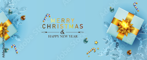 Christmas light blue holiday card, composition with gift box with gold bow.