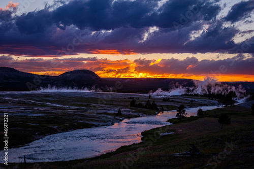 Amazing sunset at Yellowstone National Park  Wyoming. Beautiful sky above the geysers  unusual landscape.