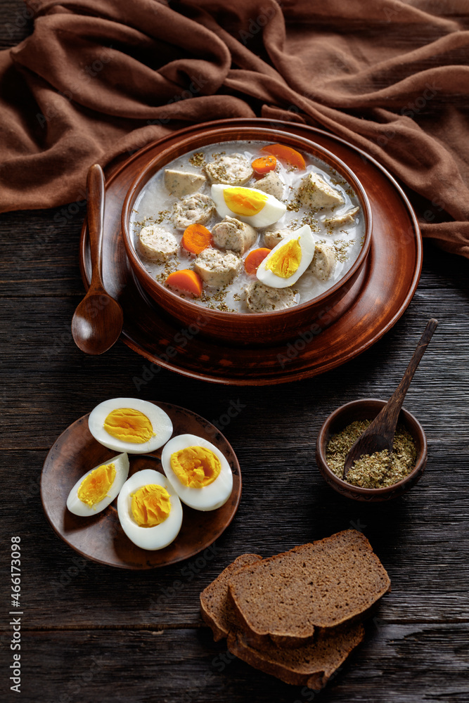 Zurek polish soup with white kielbasa on a bowl Zurek polish soup with white kielbasa on a bowl